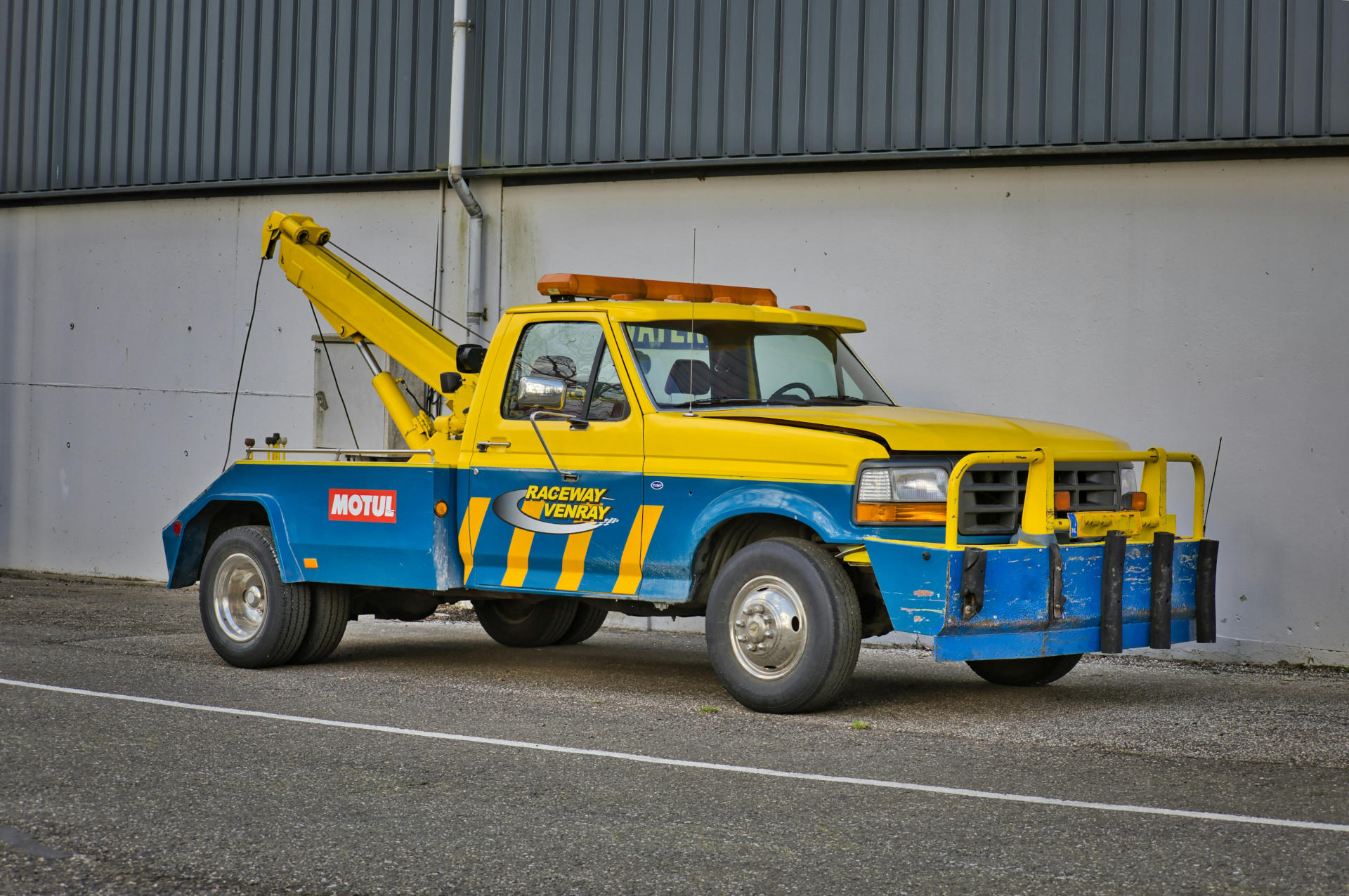 Yellow tow truck on a highway